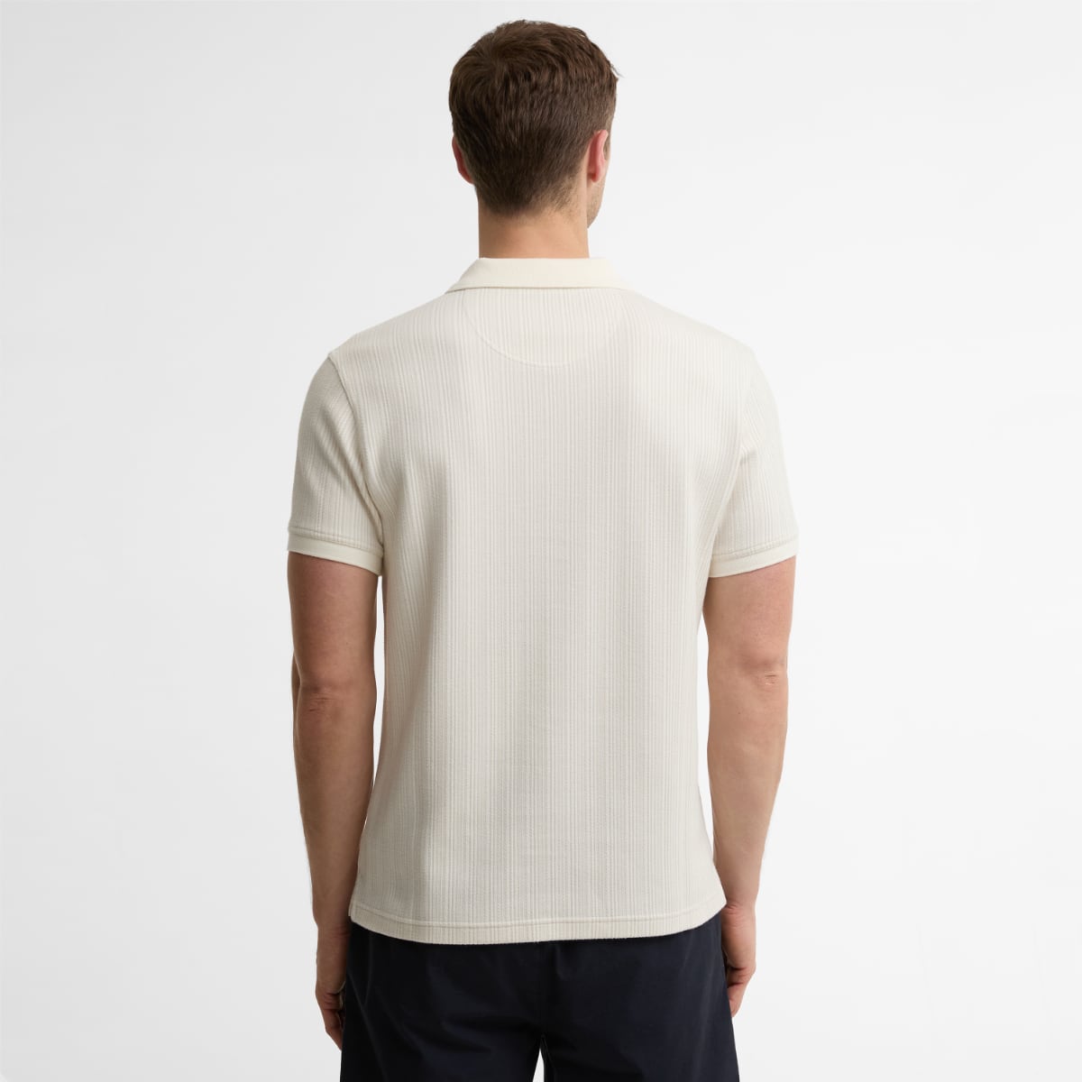 Back view of Barbour Harworth tailored men's polo shirt in Whisper White showcasing ribbed knit fabric and short sleeves.