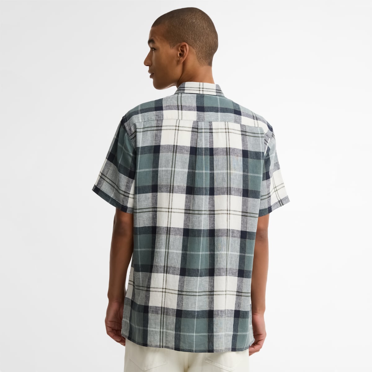 Back view of a model wearing Barbour Croft Tartan short-sleeve shirt in Meadow Brook plaid.