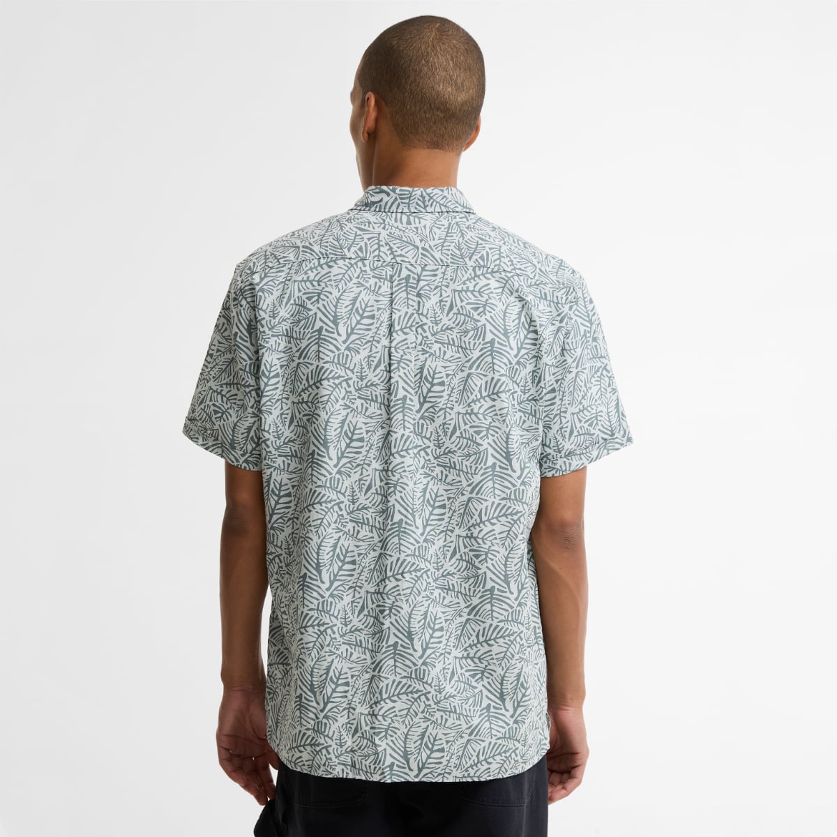 Back view of a man in Barbour Dearham short sleeve relaxed fit shirt in Dusty Slate.