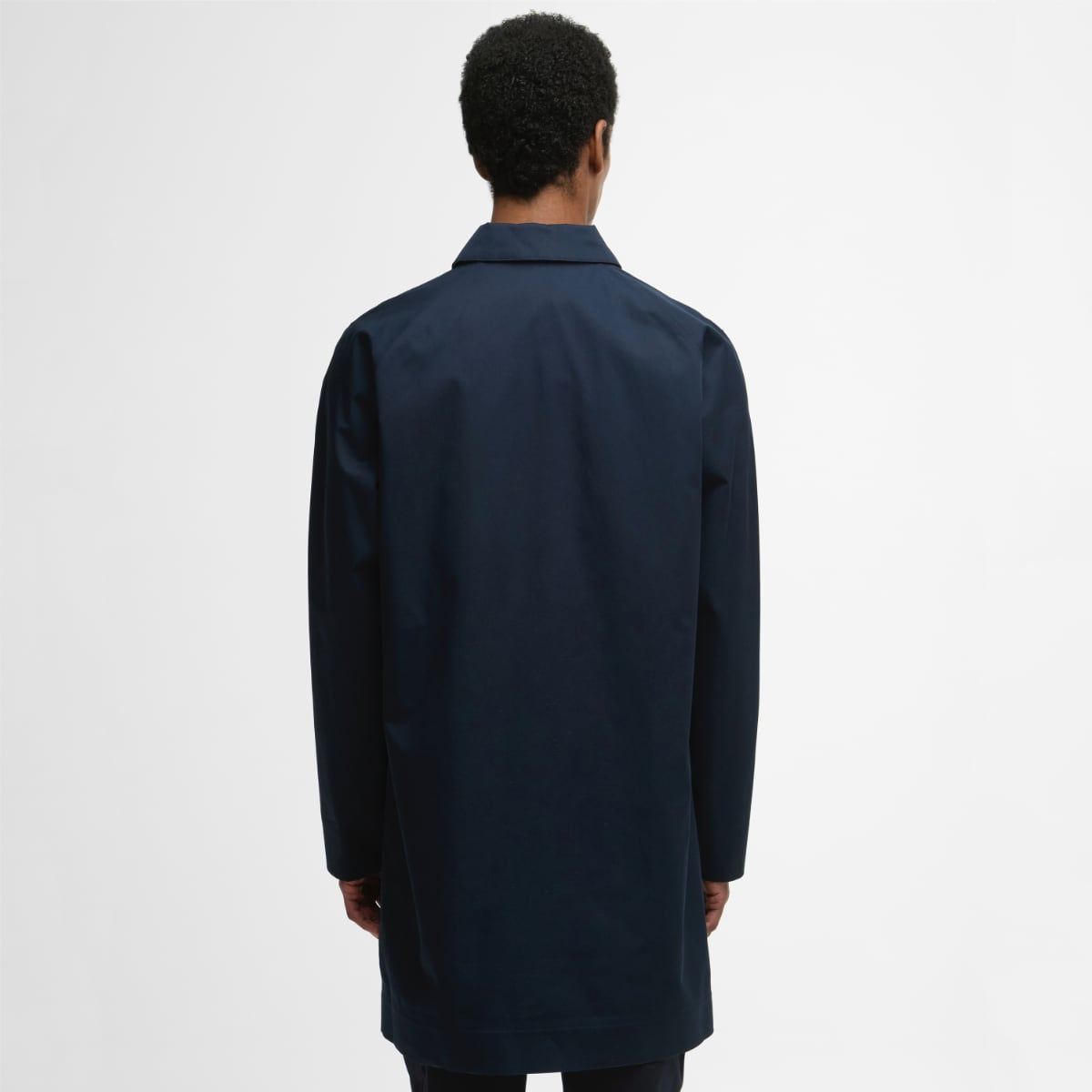 Back view of model in navy Barbour Rokig waterproof jacket, mid-thigh length