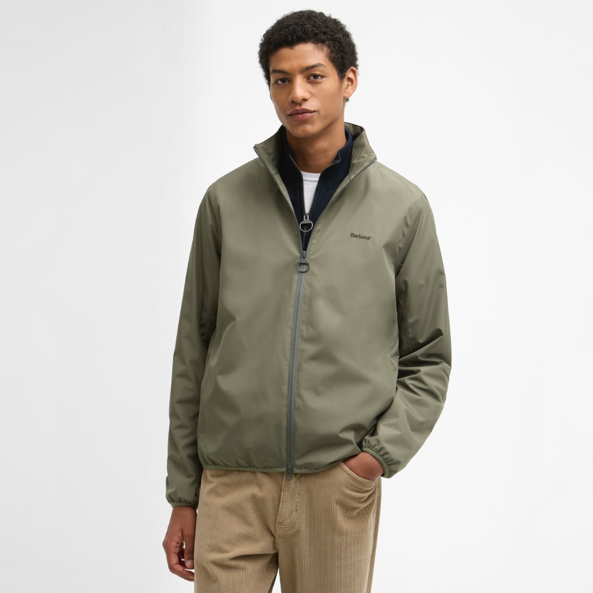Barbour Korbel Waterproof men's jacket in dusty olive worn by a model with a zip up front and stand collar