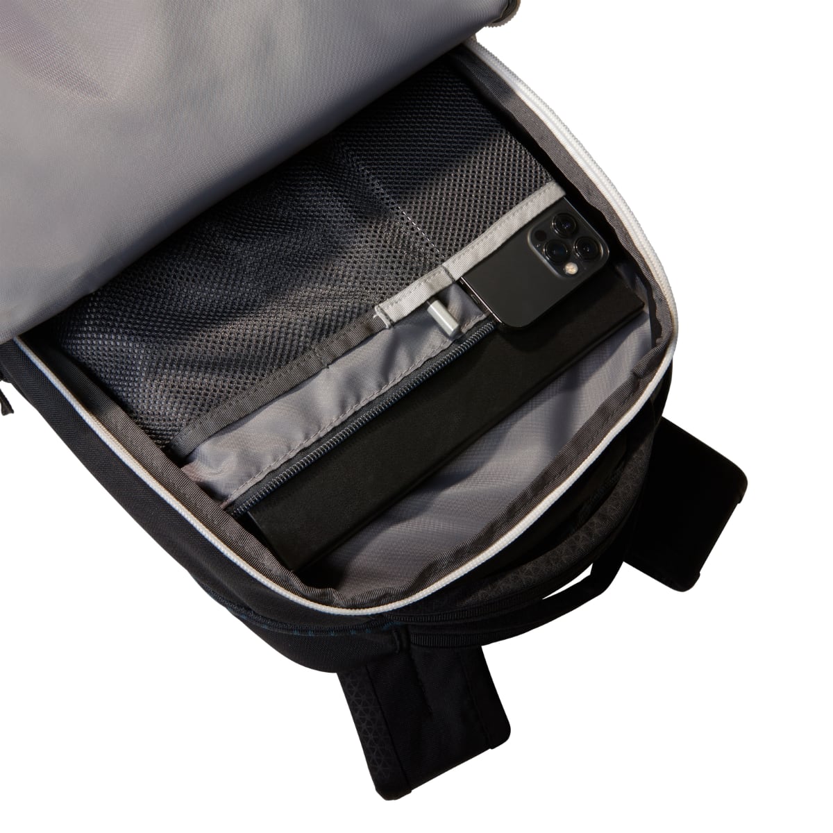 Inside view of The North Face Jester Backpack showing mesh pocket and a phone tucked into a sleeve
