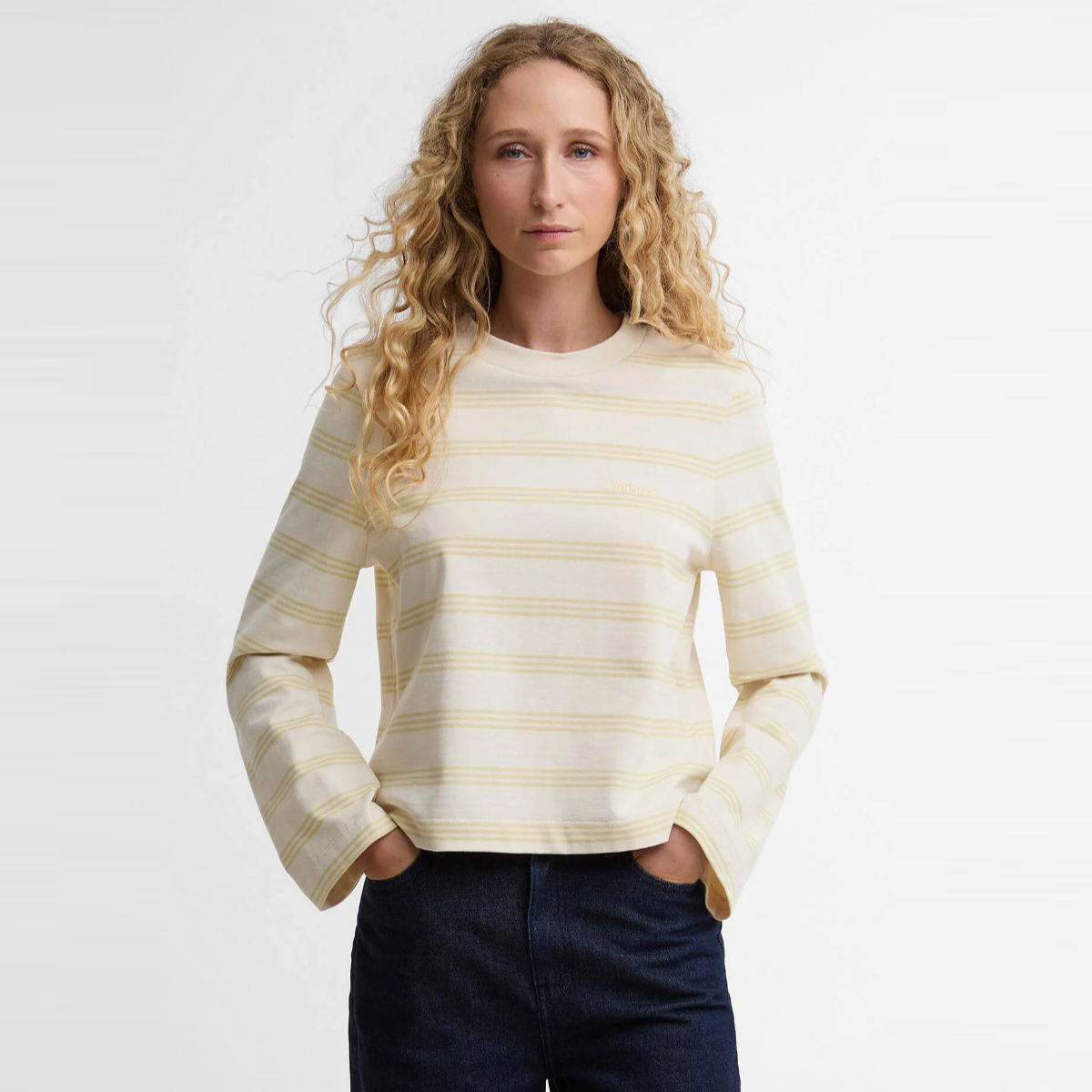 Model wearing Barbour Dartmoor striped women’s top in cream with pale yellow stripes.