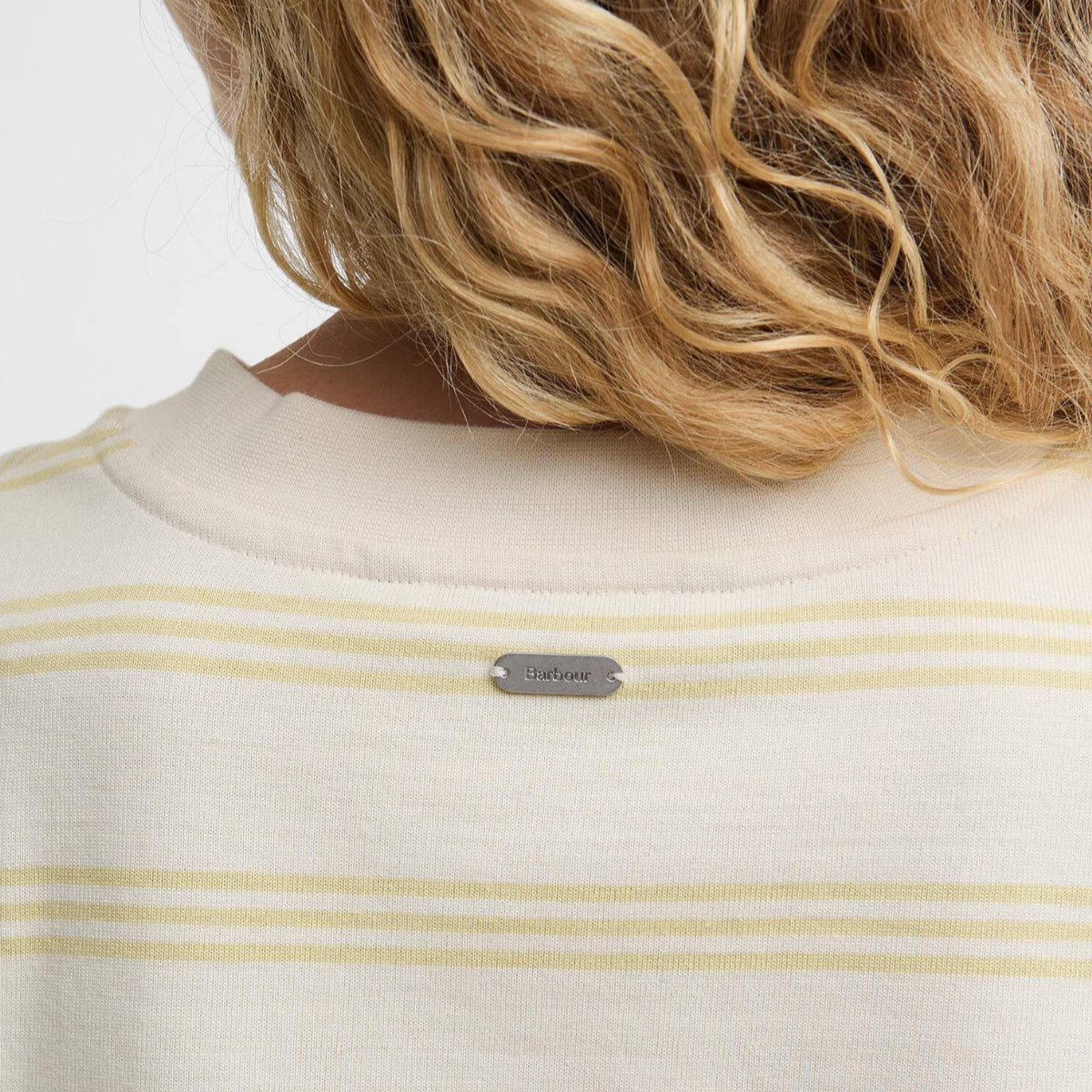 Back view of Barbour Dartmoor striped top in original ecru and soured citrus with a small metal Barbour badge.