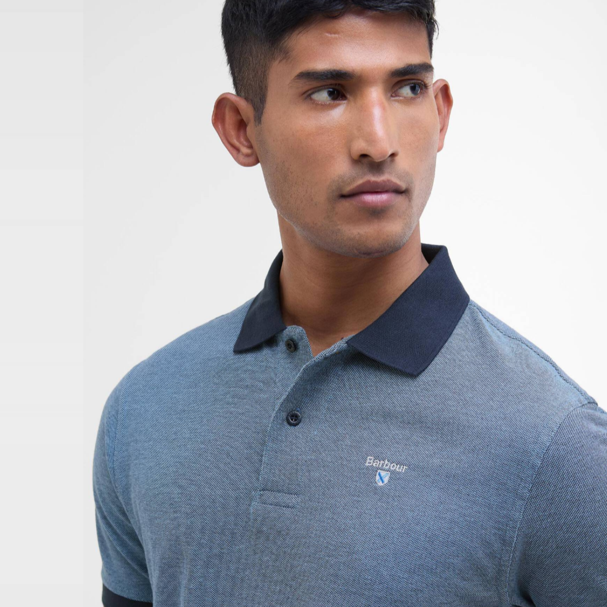 Model wearing Barbour Essential Sports Mix polo in Classic Navy with a dark navy collar and small embroidered Barbour logo on the chest