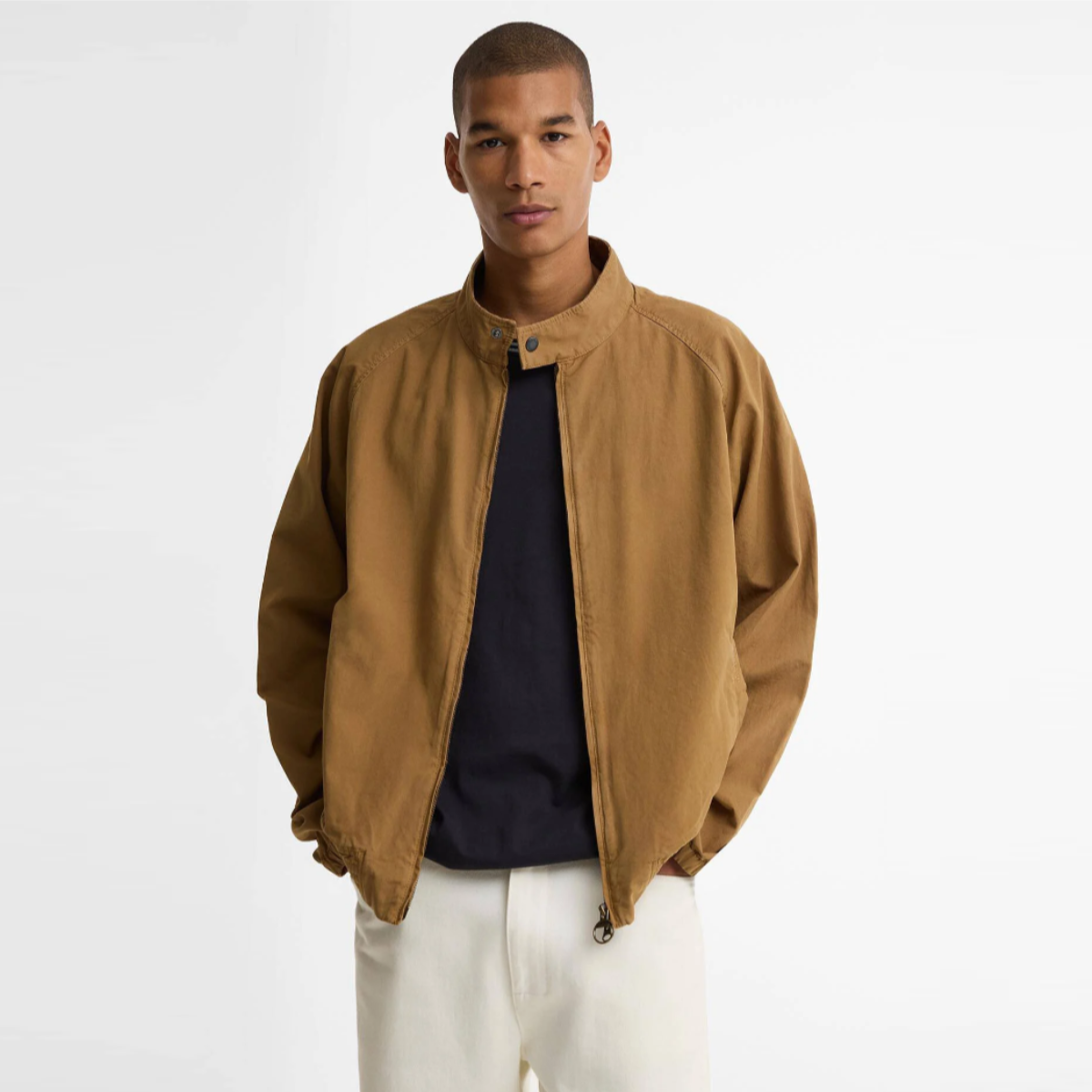 Model wearing camel Barbour Royston casual cotton Harrington jacket over a navy shirt