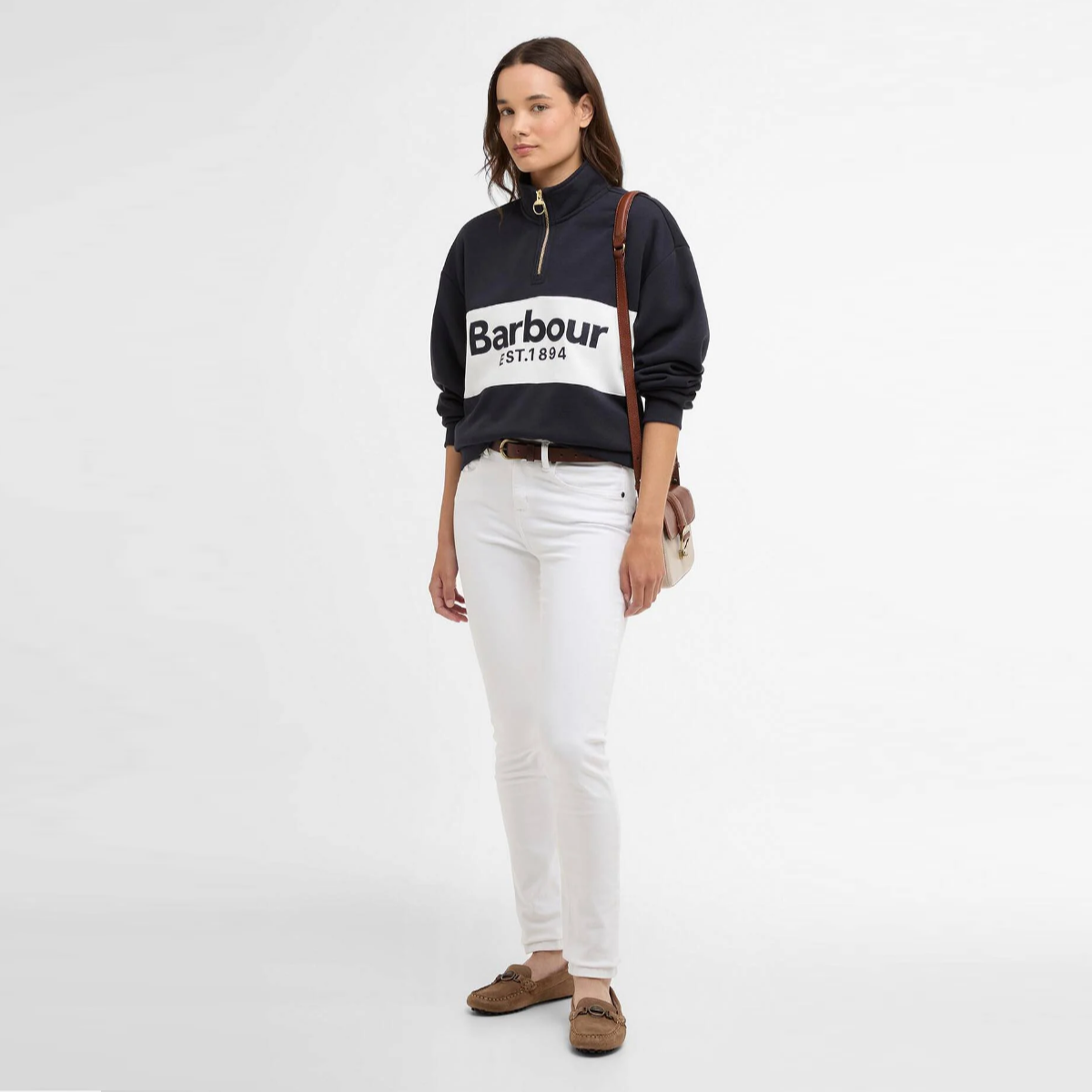 Model wearing navy Barbour Zaria quarter zip jumper with a white chest logo band.
